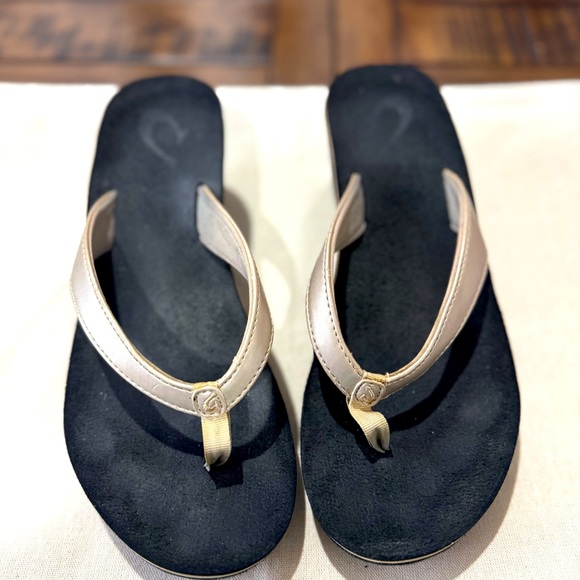 OluKai Pi'o Lua Wedge Thong Flip Flops. Gold/Black. Size 7 - Picture 1 of 6